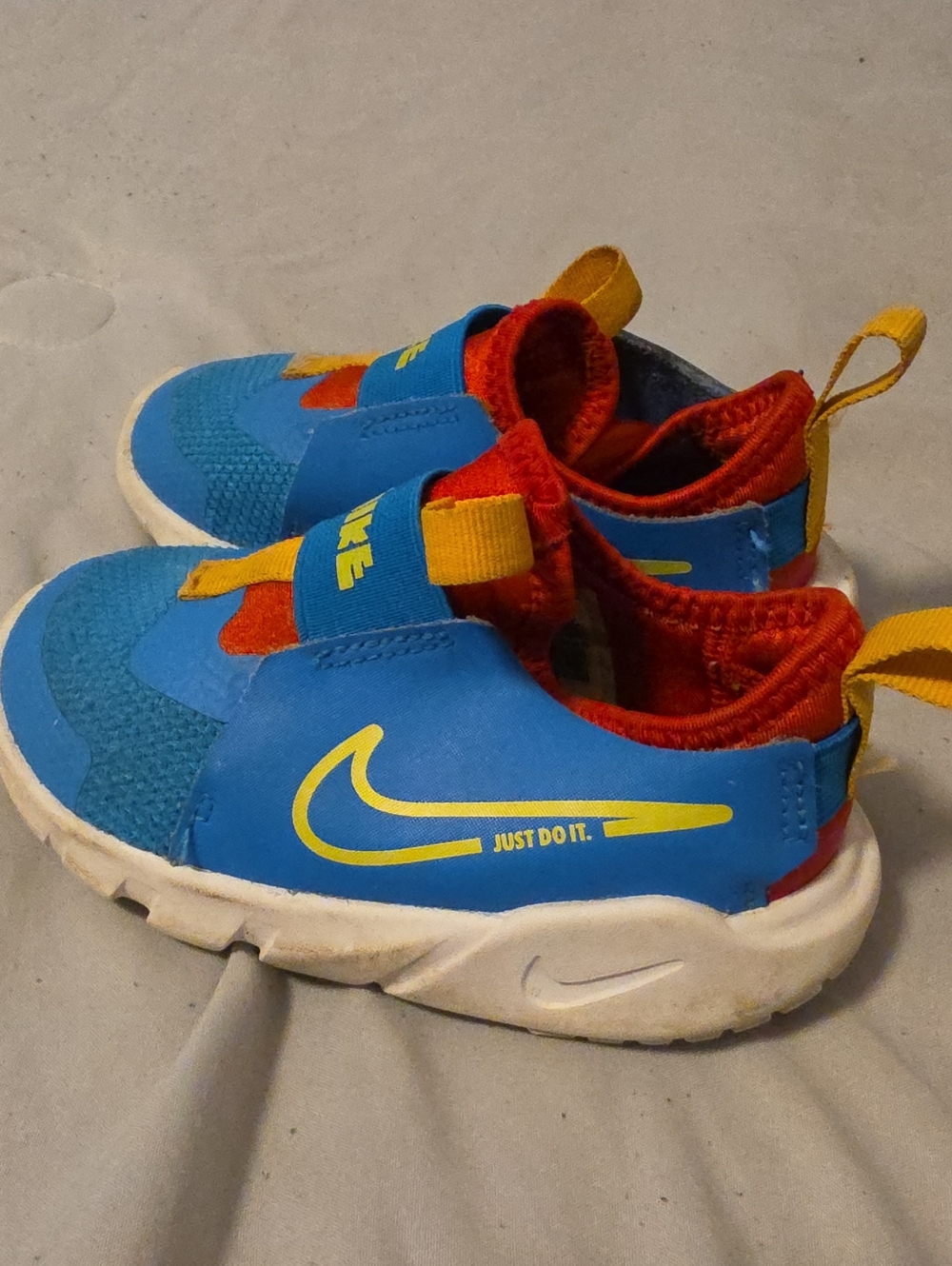 Nike Kids Blue Sneakers with Red and Yellow Accents